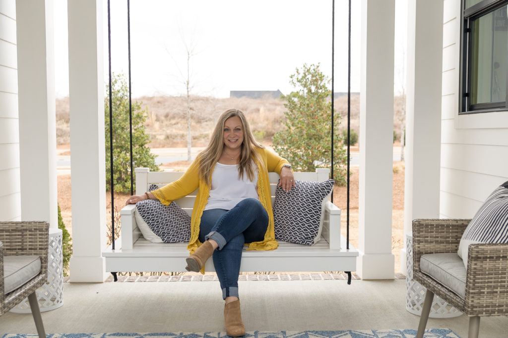 Woman wearing yellow cardigan sitting on porch swing
what to wear for branding photos 
https://sarahhouck.exprealty.com